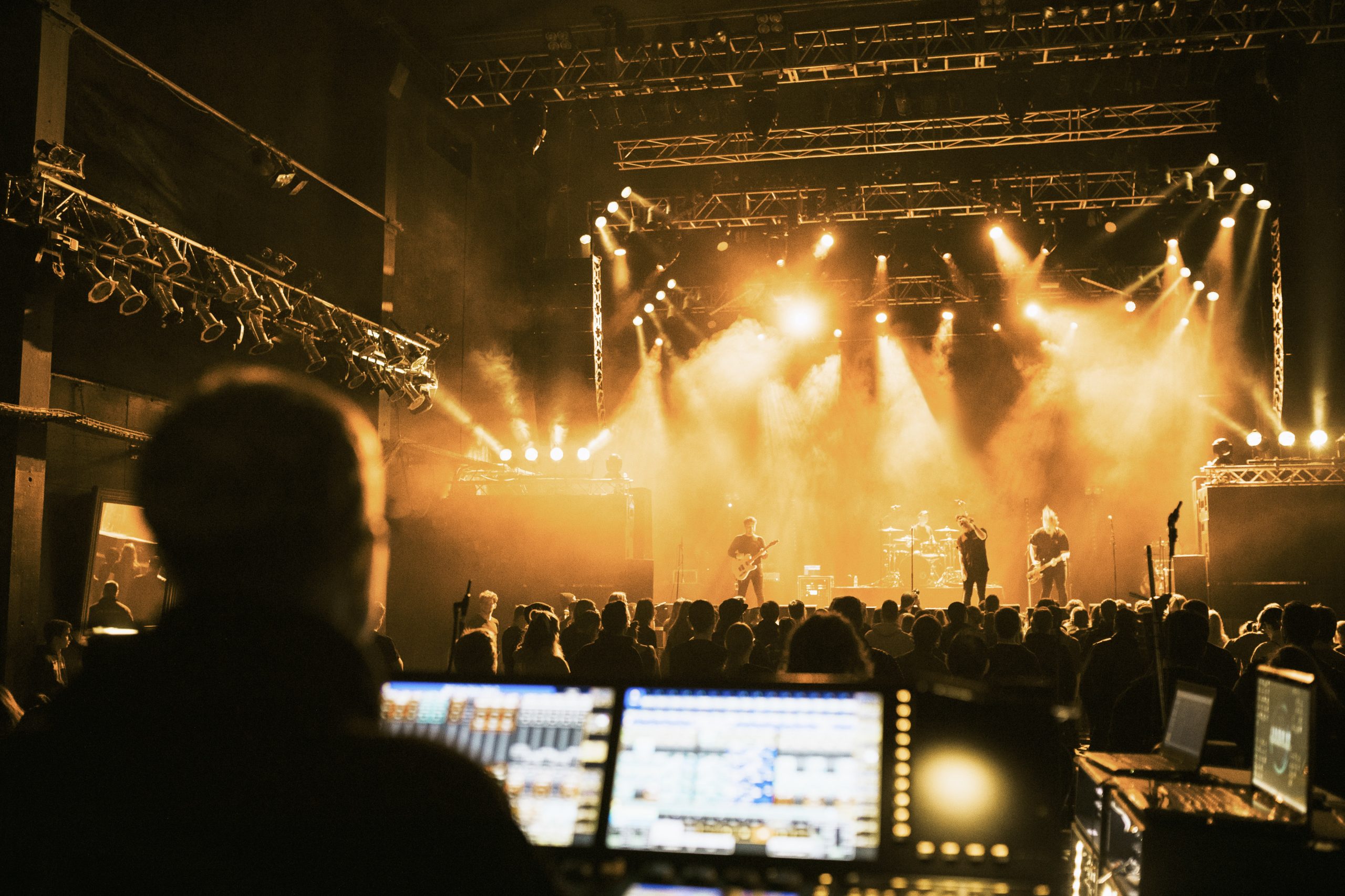 live sound engineer mixing a band on stage