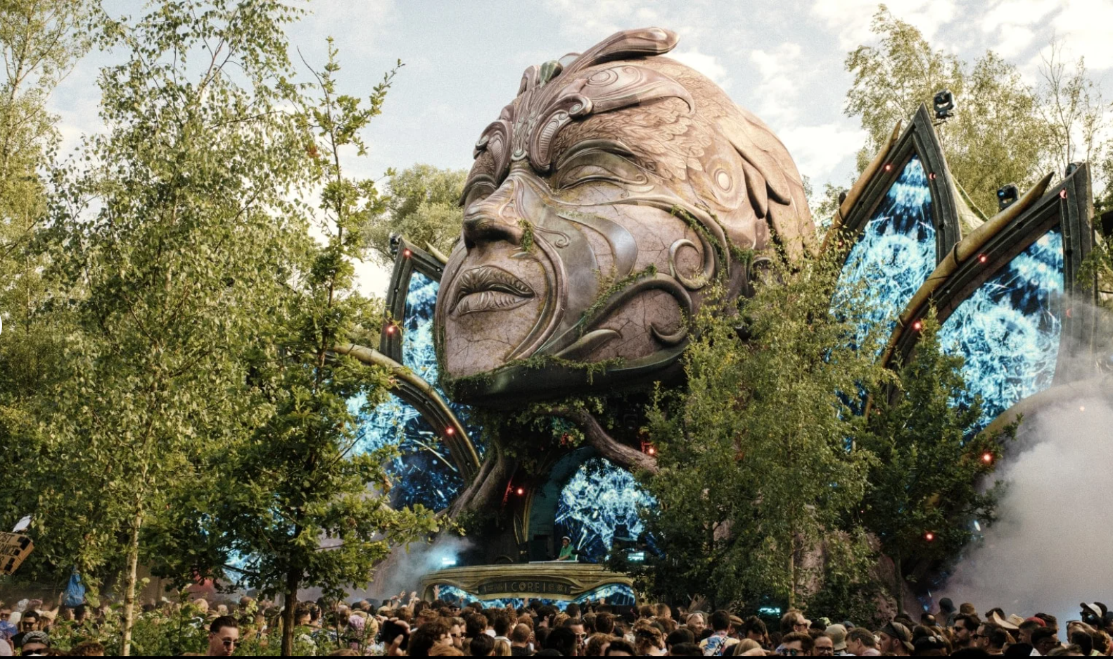 a festival stage at tomorrowland encompassed in a head