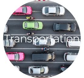Aerial view of cars in traffic on a road, with motorcycles between lanes. Text "Transportation" overlays the image. Varied colors of vehicles.